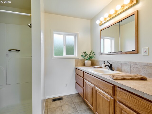 328 Mill St, Silverton, OR 97381 - bathroom with visible vents, baseboards, tile patterned flooring, a shower, and vanity