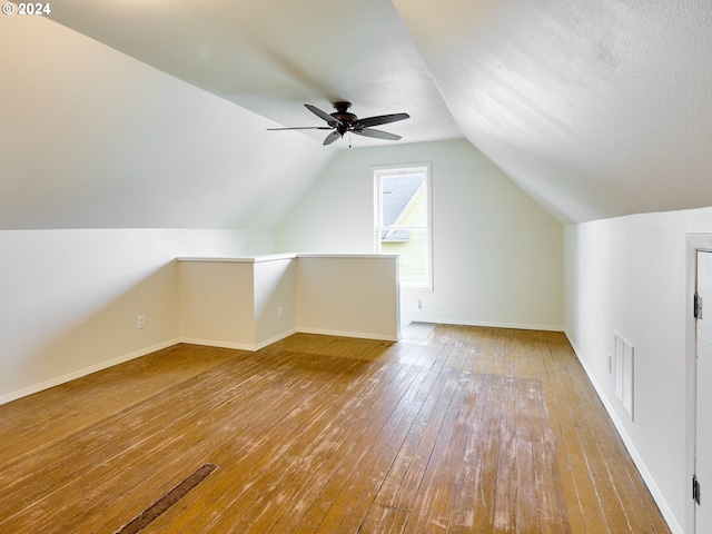 additional living space featuring lofted ceiling, wood-type flooring, and ceiling fan