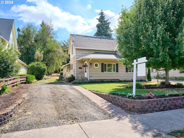 328 Mill St, Silverton, OR 97381 - view of front of home featuring fence, gravel driveway, a shingled roof, and a front lawn