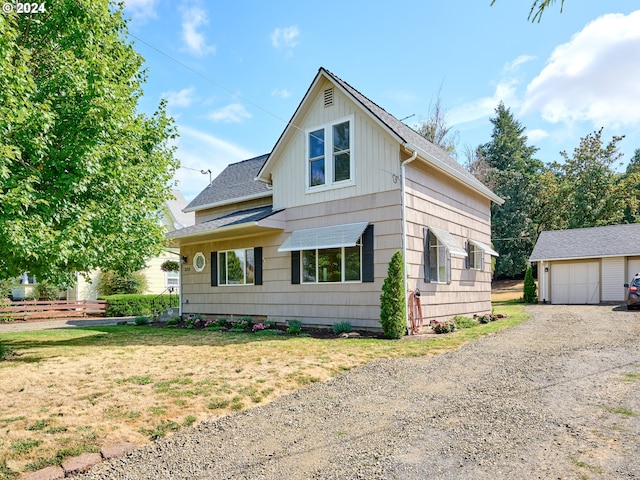 328 Mill St, Silverton, OR 97381 - view of front of home featuring a shingled roof, an outdoor structure, a front yard, and a garage