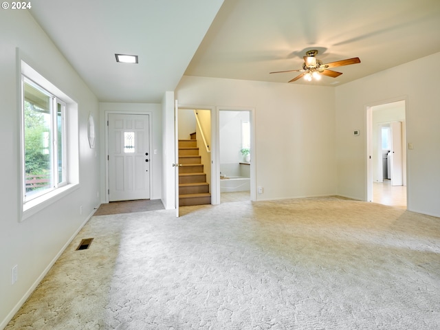 entrance foyer featuring light carpet and ceiling fan