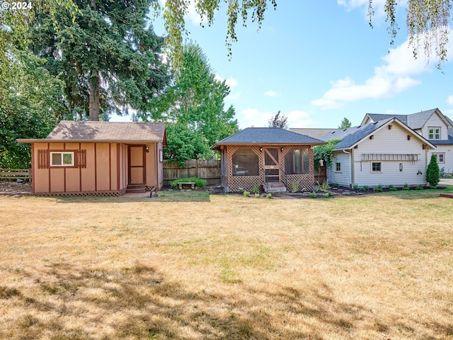 view of yard featuring a storage unit and a sunroom