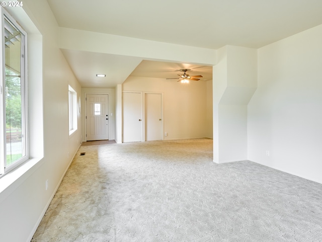 interior space with light colored carpet and ceiling fan