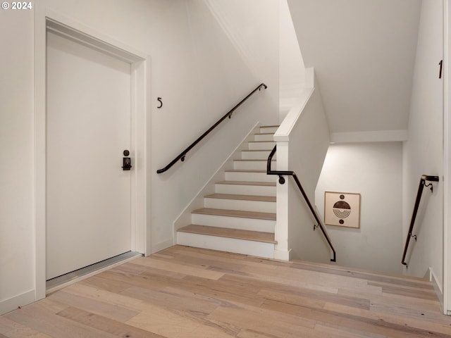 stairway featuring hardwood / wood-style flooring