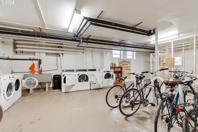 garage featuring independent washer and dryer and sink