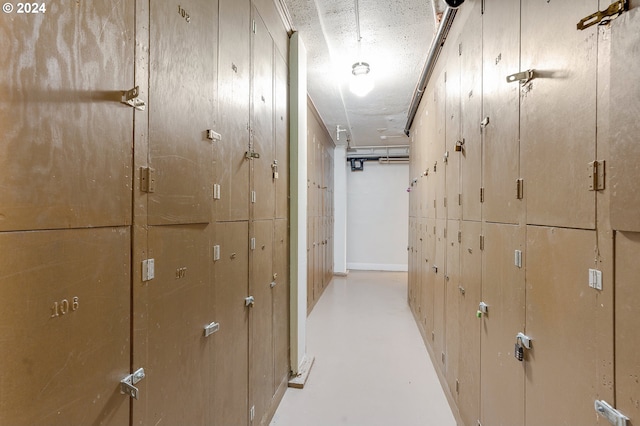 hallway with a textured ceiling