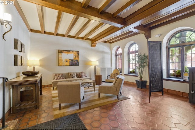 living room featuring tile patterned flooring and lofted ceiling with beams