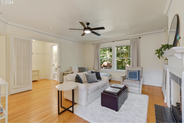 living room featuring light wood-type flooring and ceiling fan