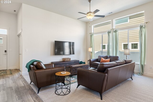 living room with ceiling fan and light wood-type flooring