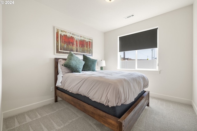 bedroom with light colored carpet