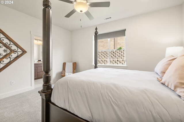 bedroom with connected bathroom, ceiling fan, and light colored carpet