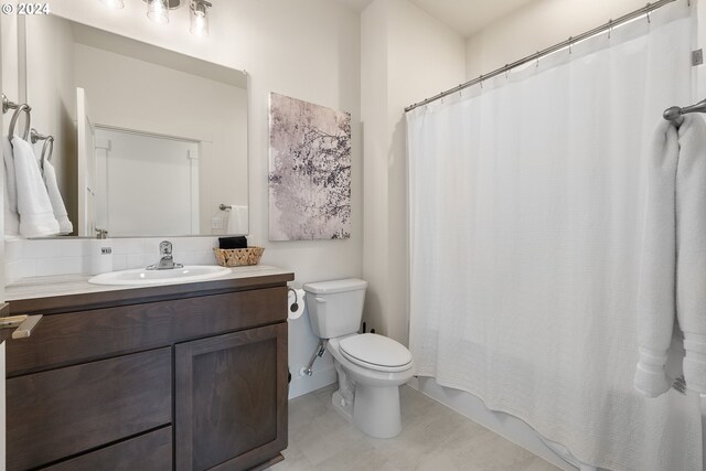 bathroom with vanity, toilet, and tile patterned flooring