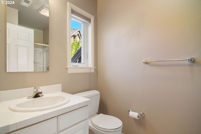 bathroom featuring toilet and large vanity