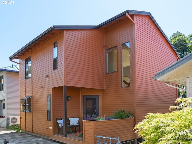 view of side of home with a wooden deck