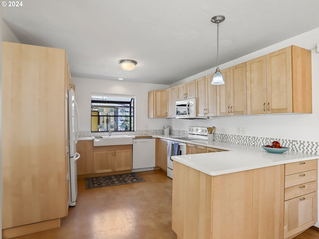 kitchen featuring light brown cabinets, white appliances, sink, hanging light fixtures, and kitchen peninsula