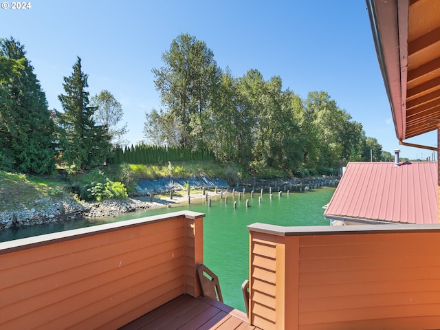 wooden terrace featuring a boat dock and a water view