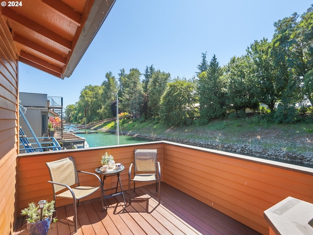 wooden deck featuring a water view