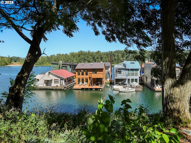 view of dock featuring a balcony and a water view