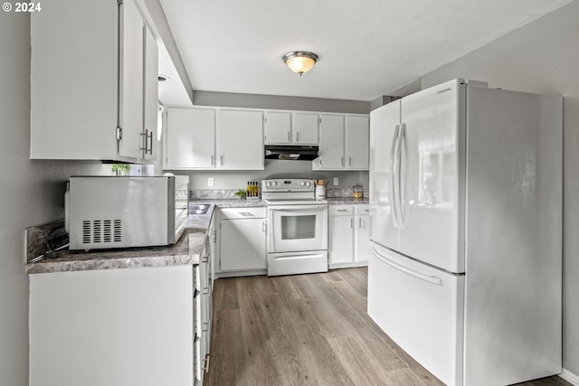 kitchen with white cabinetry, light wood-type flooring, and white appliances