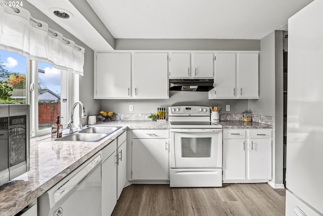 kitchen featuring white cabinets, light wood-type flooring, white appliances, and plenty of natural light