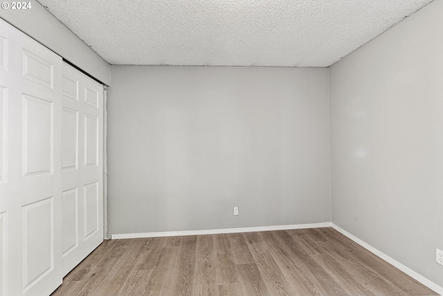 unfurnished bedroom with a closet and light hardwood / wood-style flooring