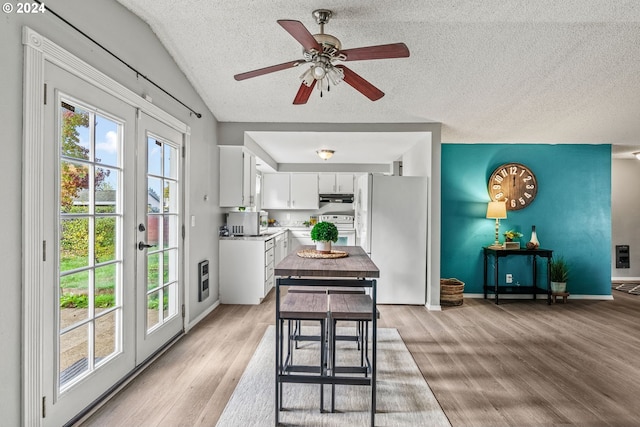 kitchen featuring light hardwood / wood-style flooring, white cabinets, french doors, and white appliances