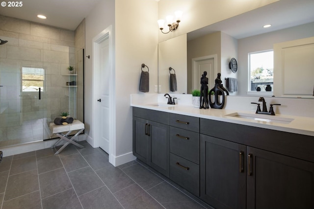 bathroom featuring vanity, a shower with shower door, and tile patterned floors