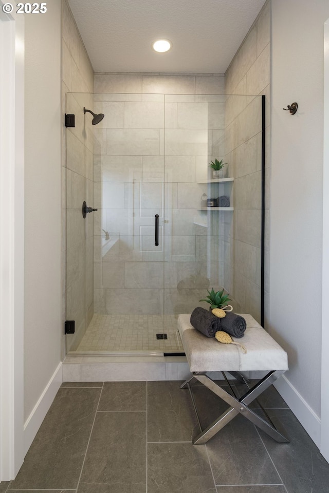 bathroom featuring tile patterned flooring and a shower with door