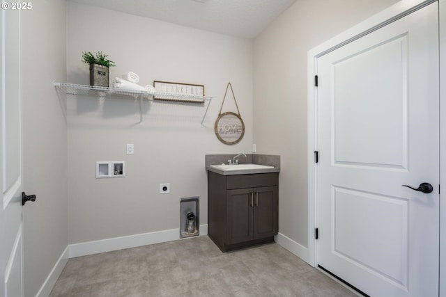 laundry room with hookup for a washing machine, sink, hookup for an electric dryer, and cabinets