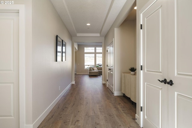 corridor featuring light hardwood / wood-style floors and a textured ceiling