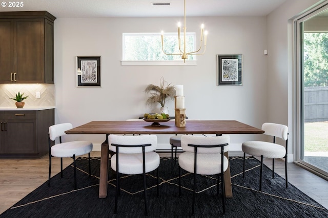 dining space featuring breakfast area, an inviting chandelier, and light hardwood / wood-style floors