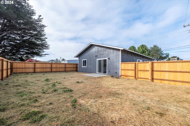 rear view of property featuring a yard