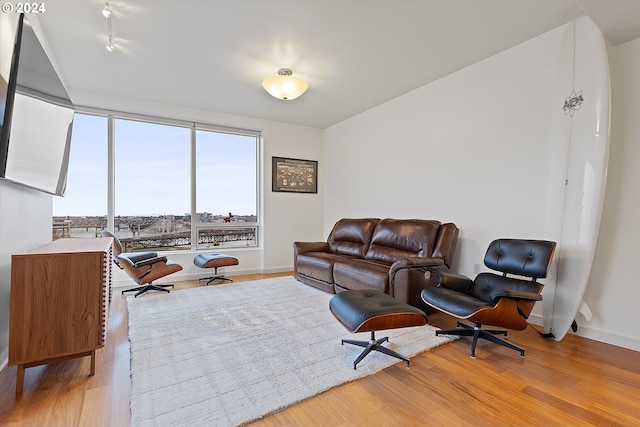 3570 S River Pkwy Unit 1609, Portland, OR 97239 - living room featuring baseboards and wood finished floors