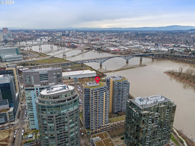 drone / aerial view featuring a water and mountain view