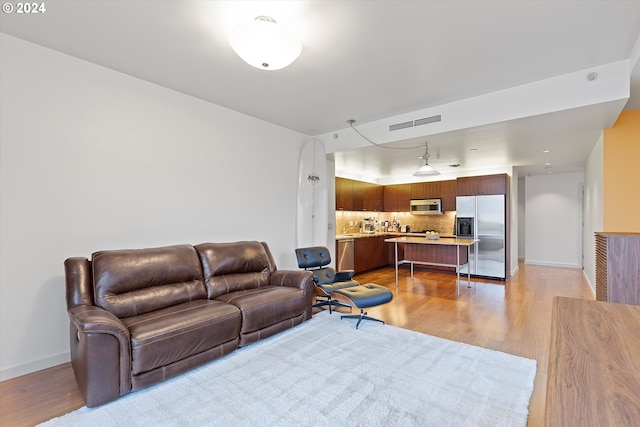 living room with light hardwood / wood-style flooring