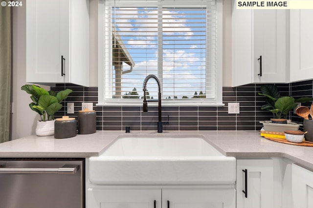 interior details with decorative backsplash, dishwasher, white cabinets, and sink