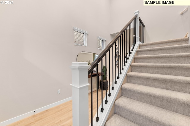 stairs featuring wood-type flooring