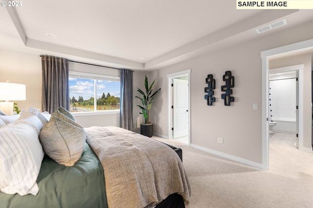 carpeted bedroom with ensuite bath