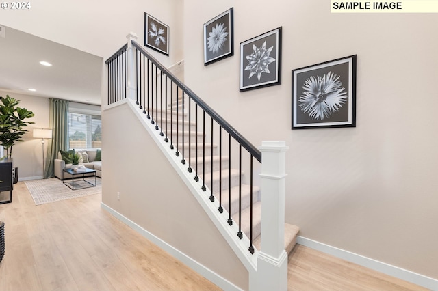 staircase featuring wood-type flooring