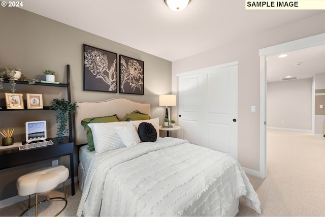 bedroom featuring light colored carpet and a closet