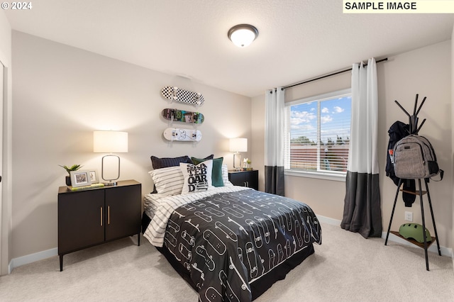 bedroom featuring light carpet