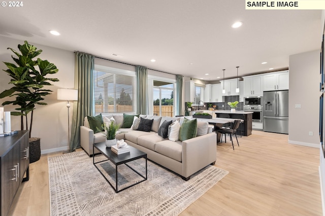 living room with light hardwood / wood-style flooring and sink