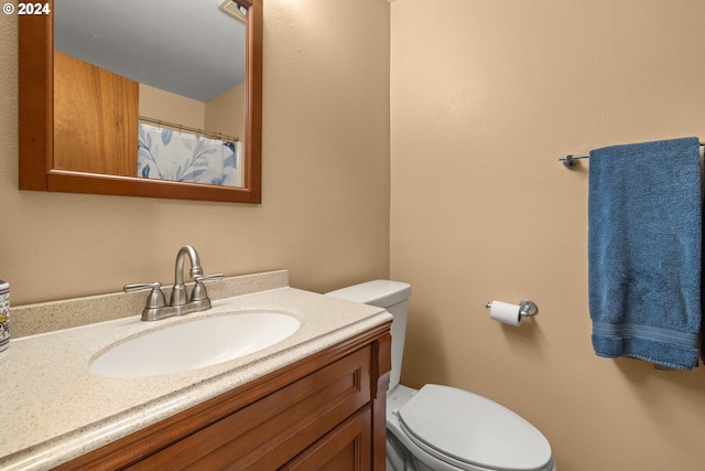 bathroom with toilet and vanity