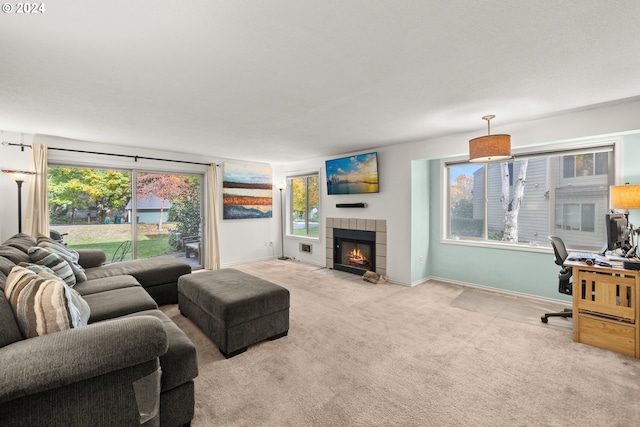 living room with light carpet, a healthy amount of sunlight, and a fireplace