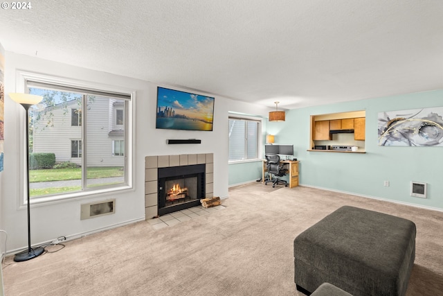 carpeted living room featuring a fireplace