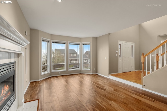 unfurnished living room with a fireplace and light hardwood / wood-style flooring