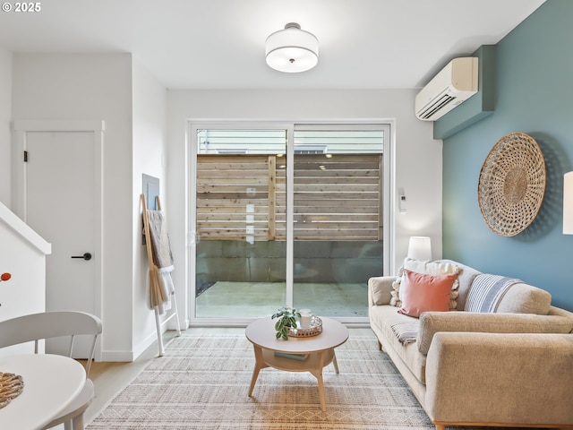 living room featuring a wall mounted air conditioner and light hardwood / wood-style flooring