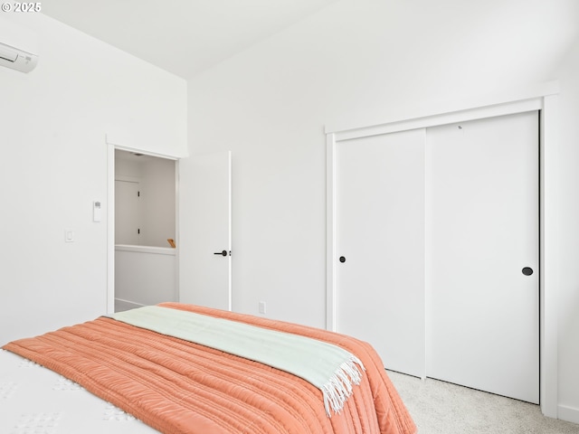 unfurnished bedroom with light colored carpet, a wall mounted AC, and a closet