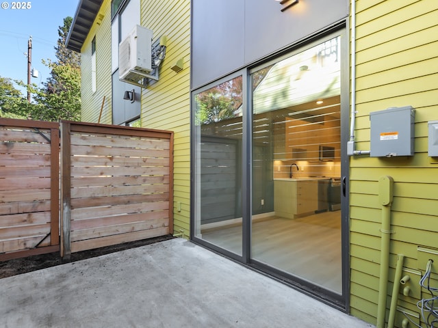 doorway featuring cooling unit and wood walls