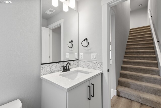 bathroom with vanity and hardwood / wood-style flooring